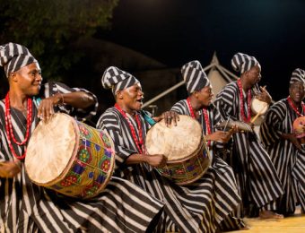 Gorizia, Italy - August 27, 2017: Musician of Benin traditional dance company following the dancers in the town street during the International Folklore Festival in Gorizia, Italy